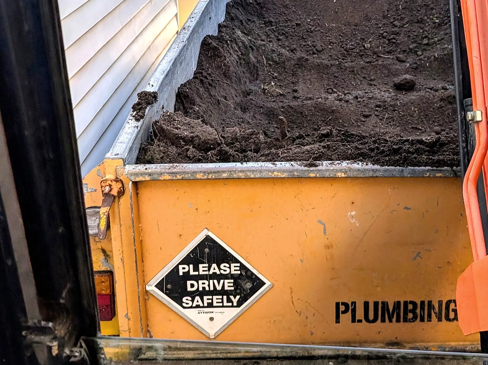 The tray of Giant Plumbing's tip truck loaded with spoil from a dig