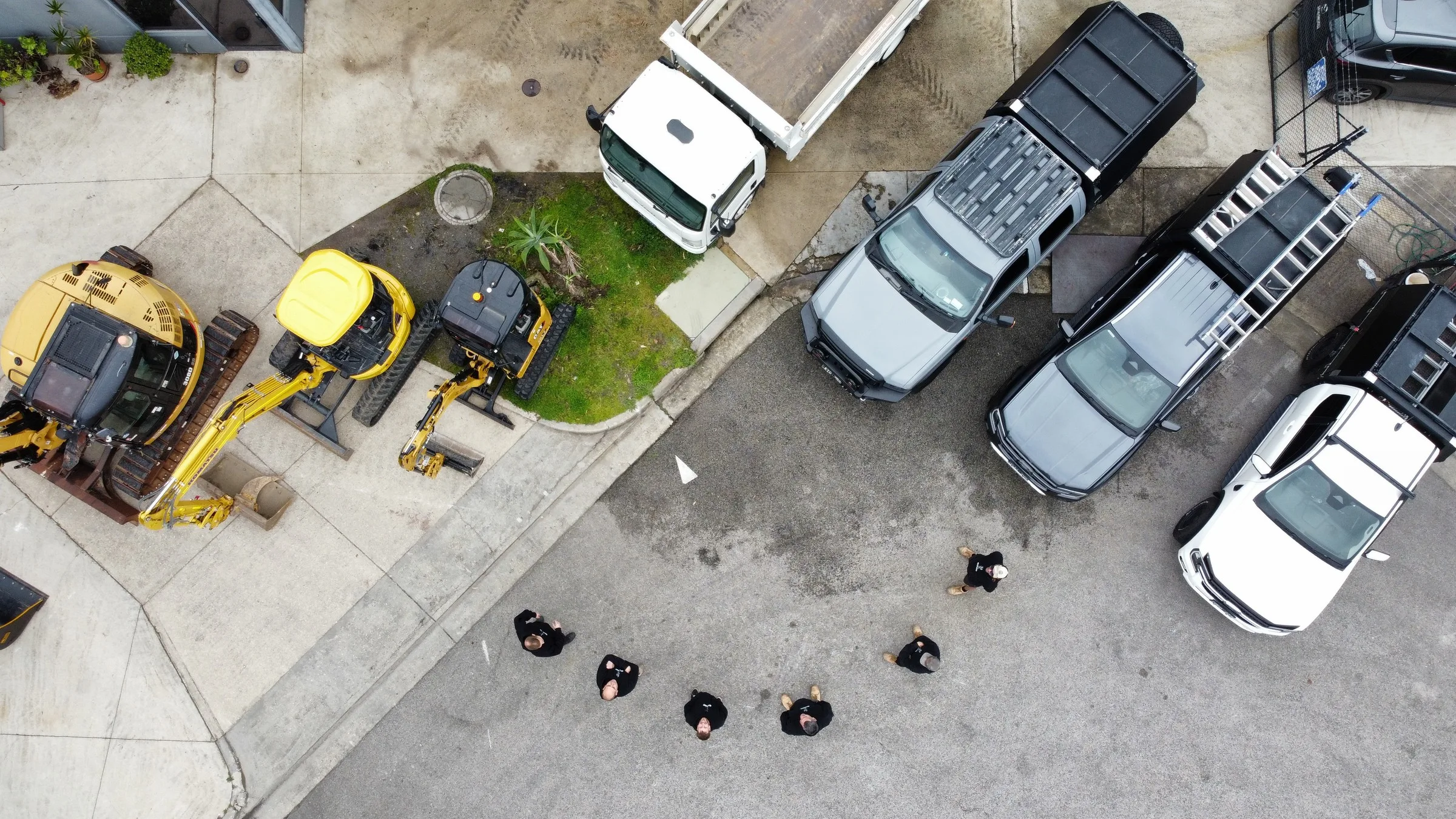 Giant Plumbing excavators, tip truck, utes and crew at the Coburg North yard, seen from above