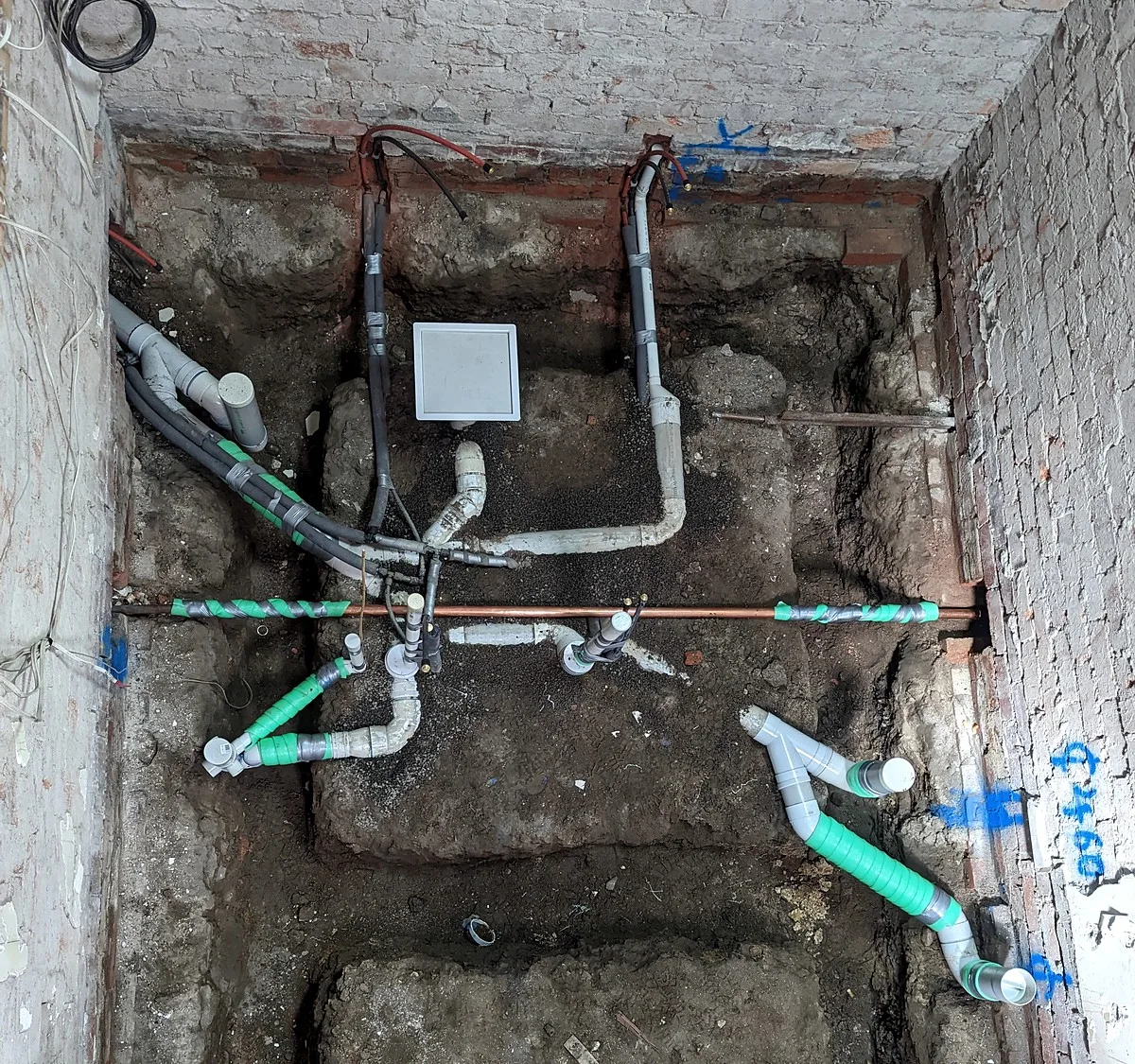 New PVC drainage and a copper water service in an excavated pit on a Melbourne commercial plumbing job