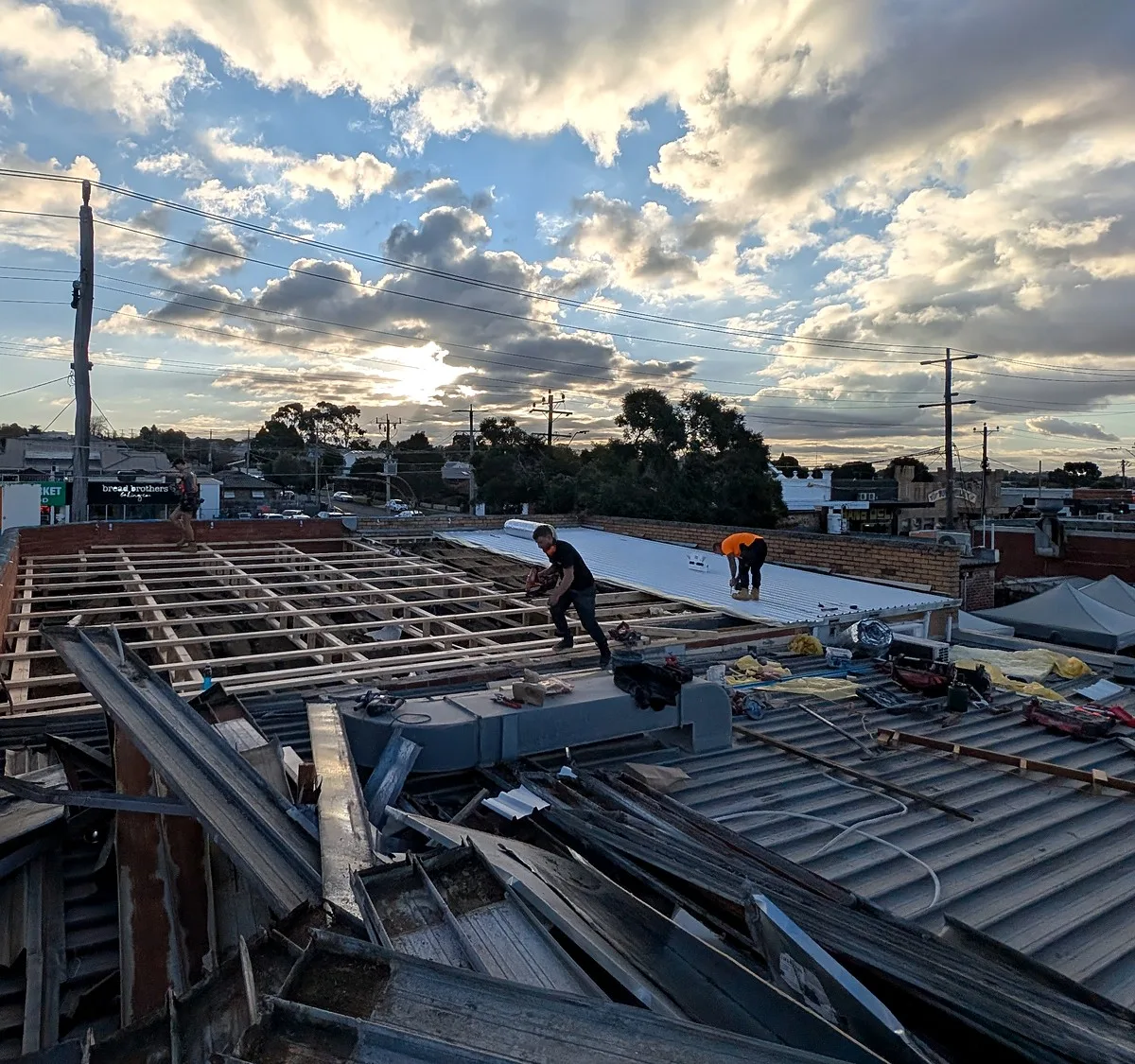 Commercial roof replacement in Melbourne, old roof sheets stripped and new metal sheets laid by Giant Plumbing